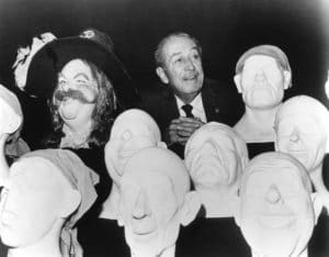 Walt Disney poses with sculpted models that were used to create Audio-Animatronics figures for the Pirates of the Caribbean attraction